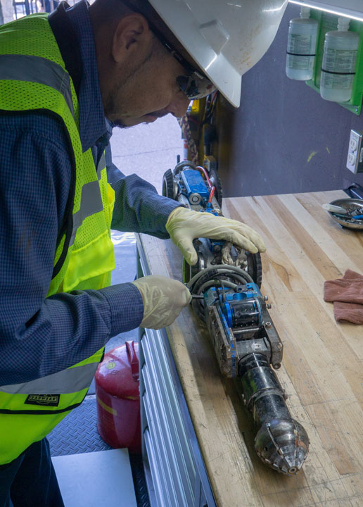 Shenandoah worker inspecting CCTV device-Chemical Grouting & Pipe Sealing